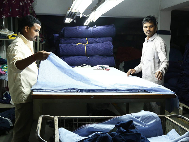 Fabric relaxing and spreading process